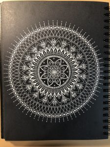 Mandala on black paper - white gelly roll pen
